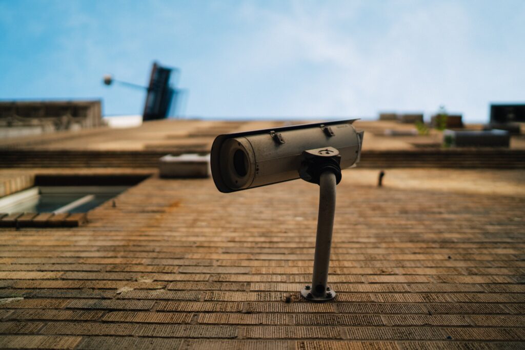 Gray security camera on a bricks wall
